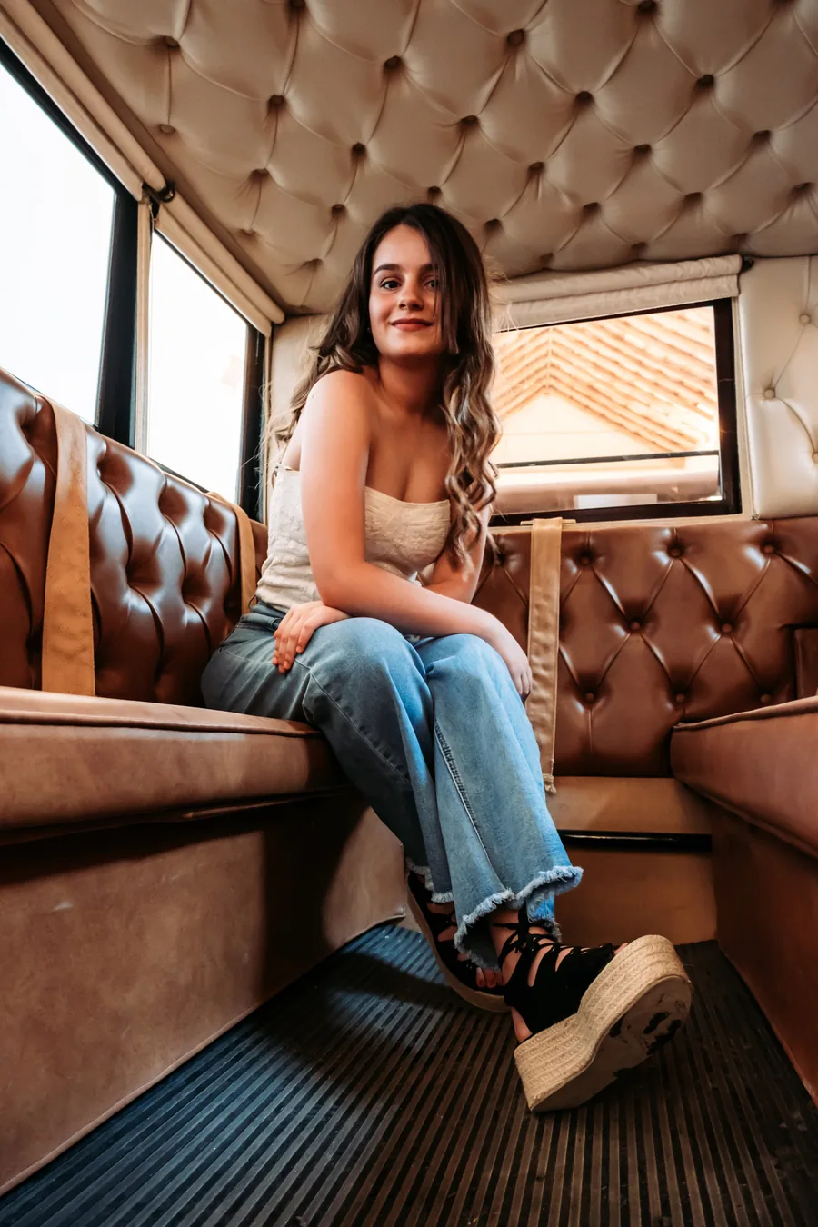 Passenger seated on the tufted leather bench of a Blackdoor Limo